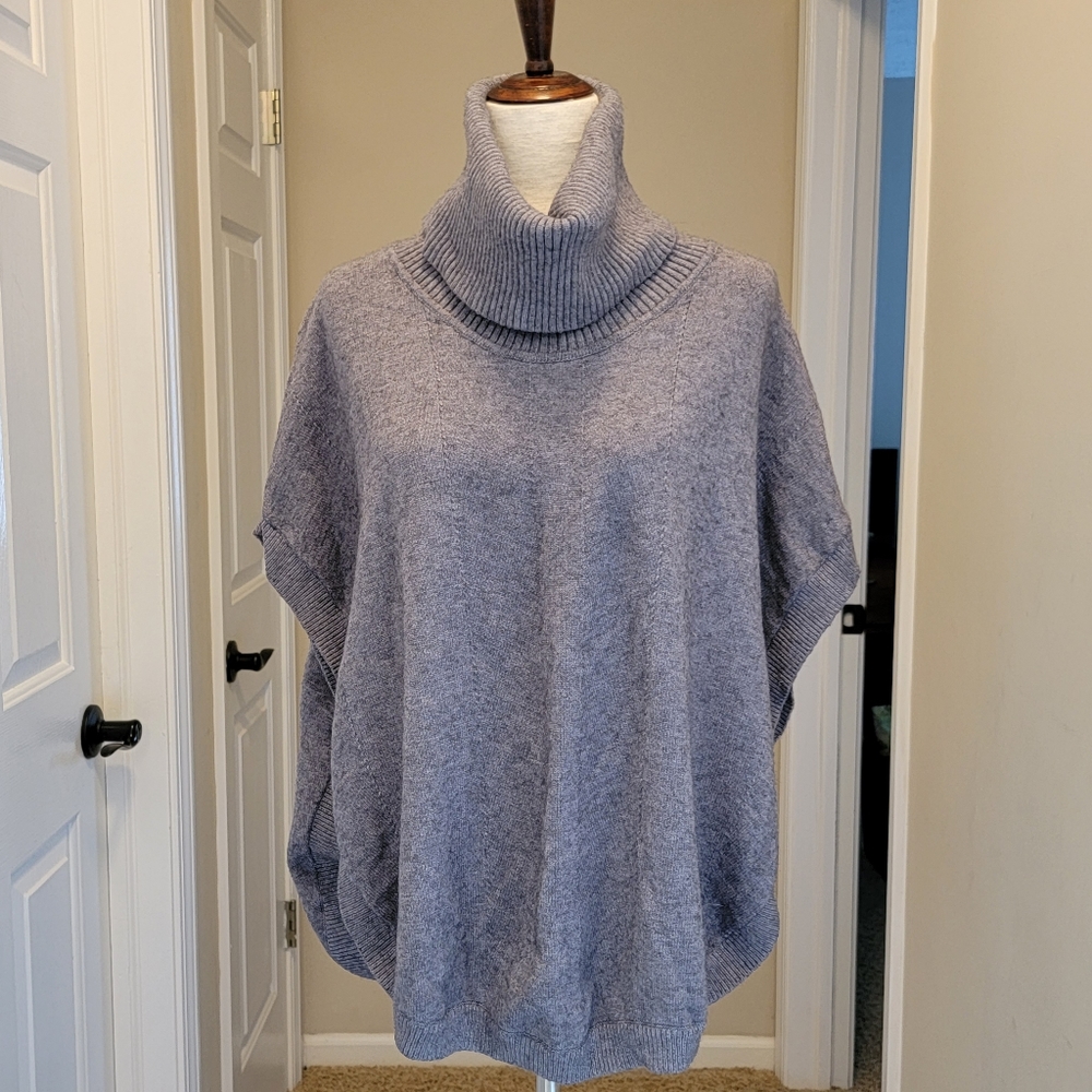 Women's drop shoulder sleeveless sweater with button up side.